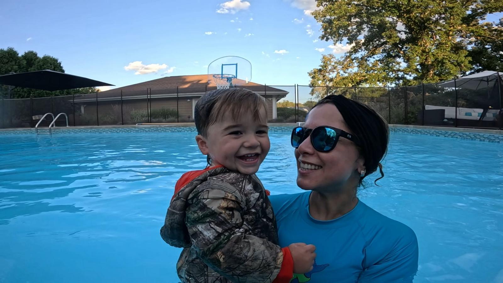 Toddler smiling in a bright pool